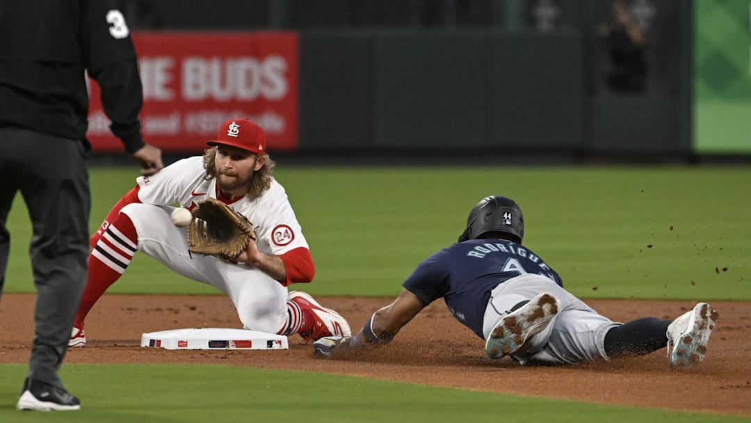 Sep 6, 2024; St. Louis, Missouri, USA; Seattle Mariners center fielder Julio Rodriguez (44) safely steals second base ahead of the tag from St. Louis Cardinals second baseman Brendan Donovan (33) in the first inning at Busch Stadium. Mandatory Credit: Joe Puetz-Imagn Images