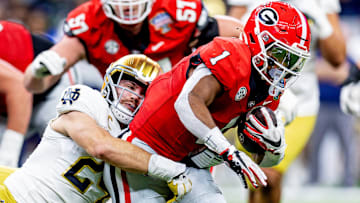 Jan 2, 2025; New Orleans, LA, USA; Georgia Bulldogs defensive back Ellis Robinson IV (1) is tackled by Notre Dame Fighting Irish linebacker Jack Kiser (24) during the second quarter at Caesars Superdome. Mandatory Credit: Stephen Lew-Imagn Images