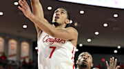 Houston Cougars guard Milos Uzan (7) scores in the first half against the Louisiana Ragin Cajuns at Fertitta Center.