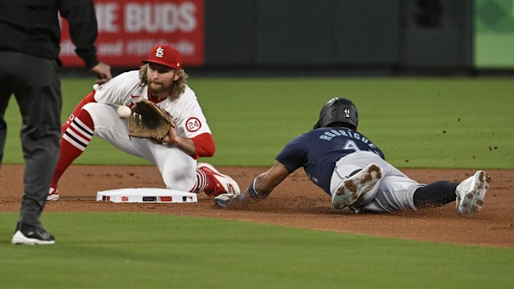 Sep 6, 2024; St. Louis, Missouri, USA; Seattle Mariners center fielder Julio Rodriguez (44) safely steals second base ahead of the tag from St. Louis Cardinals second baseman Brendan Donovan (33) in the first inning at Busch Stadium. Mandatory Credit: Joe Puetz-Imagn Images