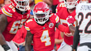 Sep 15, 2024; Kansas City, Missouri, USA; Kansas City Chiefs wide receiver Rashee Rice (4) is helped up by guard Trey Smith (65) against the Cincinnati Bengals after a penalty during the second half at GEHA Field at Arrowhead Stadium. Mandatory Credit: Denny Medley-Imagn Images