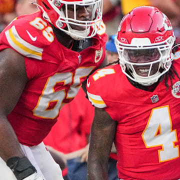 Sep 15, 2024; Kansas City, Missouri, USA; Kansas City Chiefs wide receiver Rashee Rice (4) is helped up by guard Trey Smith (65) against the Cincinnati Bengals after a penalty during the second half at GEHA Field at Arrowhead Stadium. Mandatory Credit: Denny Medley-Imagn Images