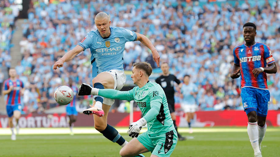 Dean Henderson (centre) handling the ball outside his box.