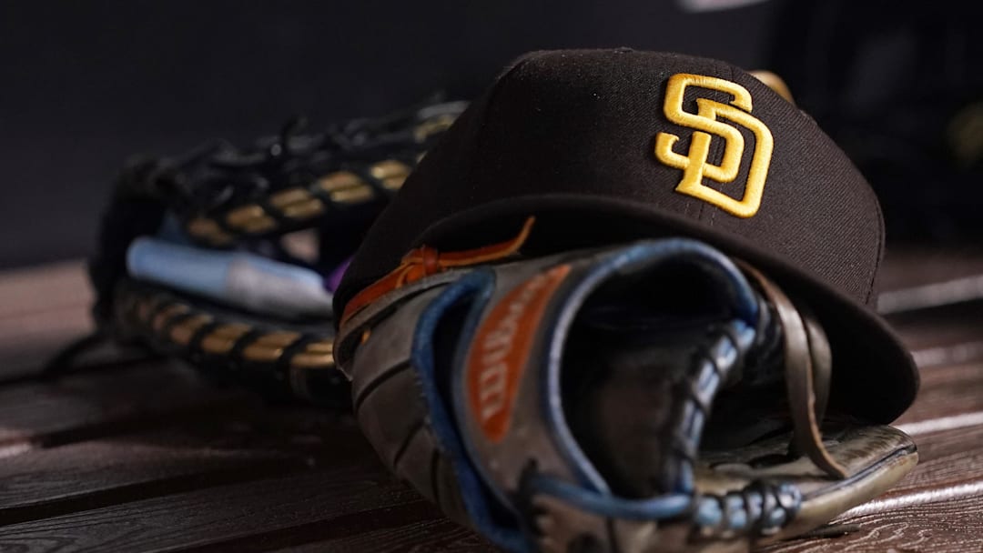 A general view of a San Diego Padres hat and glove in the dugout prior to the game between the Miami Marlins and the San Diego Padres at loanDepot park on July 23, 2021