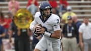 Oct 25, 2025; Houston, Texas, USA; UConn Huskies quarterback Joe Fagnano (2) rolls out of the pocket with the ball during the second quarter against the Rice Owls at Rice Stadium. Mandatory Credit: Troy Taormina-Imagn Images