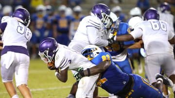 Gainesville High School Joh Cooper (9) is tackled by Newberry High School's Jarquez Carter (92) as he runs the ball, during a spring football game at NHS in Newberry FL. May 20, 2022. [Brad McClenny/The Gainesville Sun]

Flgai 052022 Ghsvnewberryspringfb 09