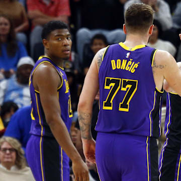 Mar 29, 2025; Memphis, Tennessee, USA; Los Angeles Lakers guard Austin Reaves (15) reacts with guard Luka Doncic (77) after a basket during the fourth quarter against the Memphis Grizzlies at FedExForum. Mandatory Credit: Petre Thomas-Imagn Images