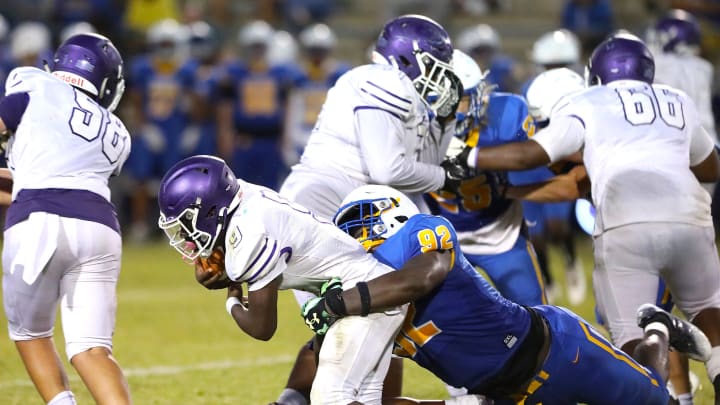 Gainesville High School Joh Cooper (9) is tackled by Newberry High School's Jarquez Carter (92) as he runs the ball, during a spring football game at NHS in Newberry FL. May 20, 2022. [Brad McClenny/The Gainesville Sun]

Flgai 052022 Ghsvnewberryspringfb 09