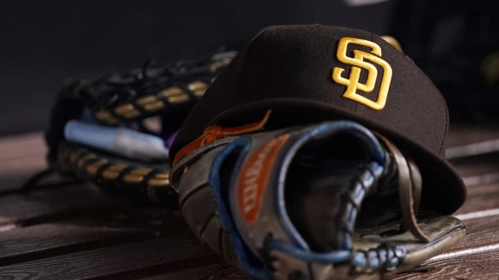 Jul 23, 2021; Miami, Florida, USA; A general view of a San Diego Padres hat and glove in the dugout prior to the game between the Miami Marlins and the San Diego Padres at loanDepot park. Mandatory Credit: Jasen Vinlove-USA TODAY Sports