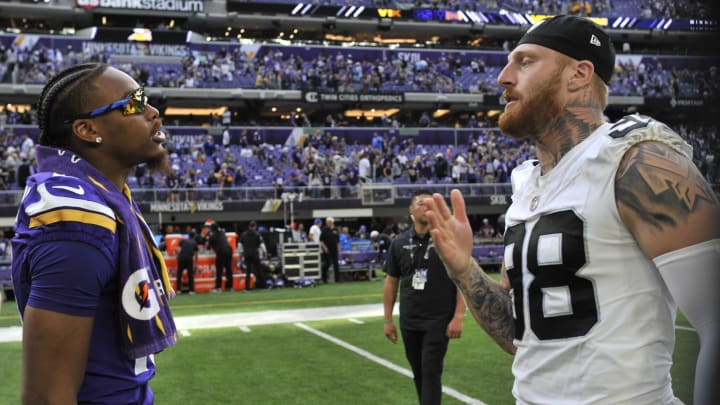 Aug 10, 2024; Minneapolis, Minnesota, USA; Minnesota Vikings wide receiver Justin Jefferson (18) and Las Vegas Raiders defensive end Maxx Crosby (98) meet after the game at U.S. Bank Stadium. Mandatory Credit: Jeffrey Becker-USA TODAY Sports