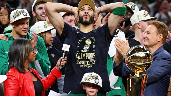 Jun 17, 2024; Boston, Massachusetts, USA; Boston Celtics forward Jayson Tatum (0) celebrates with the Larry O’Brien Trophy after beating the Dallas Mavericks in game five of the 2024 NBA Finals to win the NBA Championship at TD Garden. Mandatory Credit: Peter Casey-USA TODAY Sports