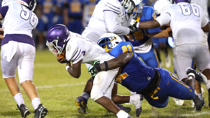 Gainesville High School Joh Cooper (9) is tackled by Newberry High School's Jarquez Carter (92) as he runs the ball, during a spring football game at NHS in Newberry FL. May 20, 2022. [Brad McClenny/The Gainesville Sun]

Flgai 052022 Ghsvnewberryspringfb 09