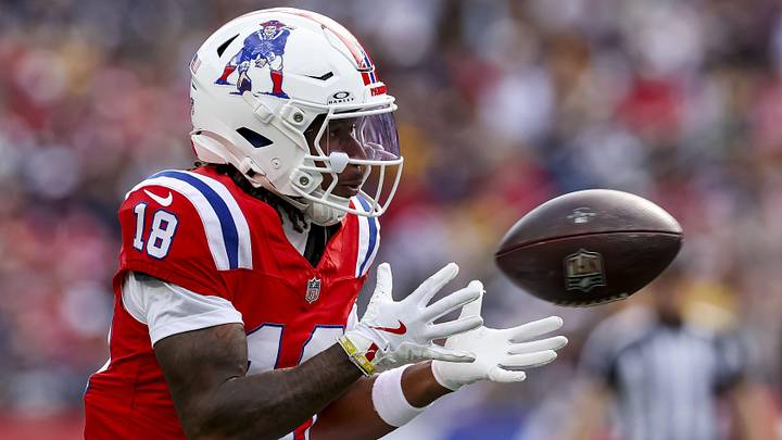 Sep 21, 2025; Foxborough, Massachusetts, USA; New England Patriots wide receiver Kyle Williams (18) completes a pass during the third quarter at Gillette Stadium. Mandatory Credit: Paul Rutherford-Imagn Images