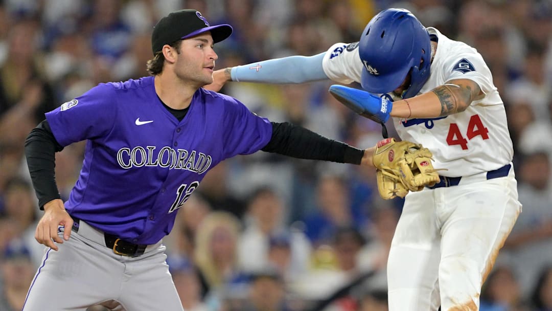 Los Angeles Dodgers center fielder Andy Pages is tagged out by Colorado Rockies third baseman Kyle Karros