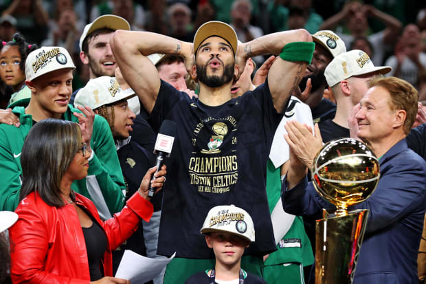 Boston Celtics forward Jayson Tatum (0) celebrates with the Larry O’Brien Trophy after winning the 2024 NBA championship.