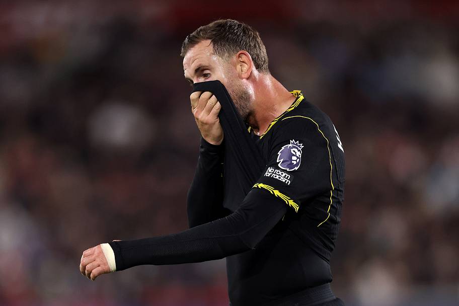 Jordan Henderson wiping his face.
