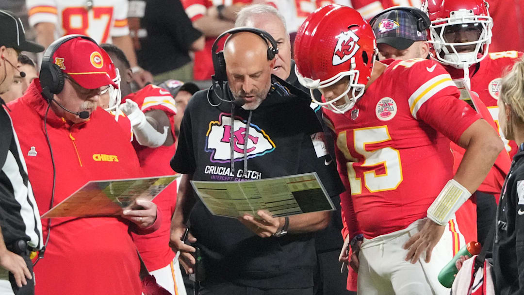 Oct 7, 2024; Kansas City, Missouri, USA; Kansas City Chiefs quarterback Patrick Mahomes (15) looks at plays with offensive coordinator Matt Nagy, center, and head coach Andy Reid against the New Orleans Saints during the first half at GEHA Field at Arrowhead Stadium.