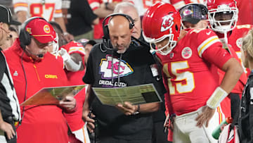 Oct 7, 2024; Kansas City, Missouri, USA; Kansas City Chiefs quarterback Patrick Mahomes (15) looks at plays with offensive coordinator Matt Nagy, center, and head coach Andy Reid against the New Orleans Saints during the first half at GEHA Field at Arrowhead Stadium.