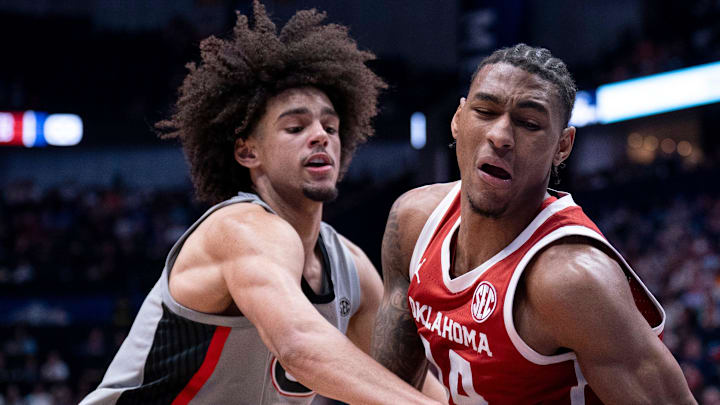 Georgia Bulldogs forward Asa Newell (14) gets to the ball after Oklahoma Sooners forward Jalon Moore (14) took control during their first round game of the SEC Men's Basketball Tournament at Bridgestone Arena in Nashville, Tenn., Wednesday, March 12, 2025. Georgia Bulldogs forward Asa Newell (14) gets to the ball after Oklahoma Sooners forward Jalon Moore (14) took control during their first round game of the SEC Men's Basketball Tournament at Bridgestone Arena in Nashville, Tenn., Wednesday, March 12, 2025.