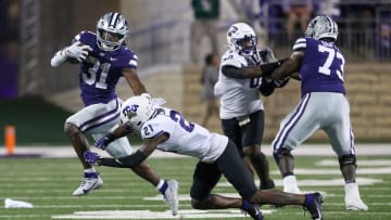 Oct 21, 2023; Manhattan, Kansas, USA; Kansas State Wildcats running back DJ Giddens (31) runs by TCU Horned Frogs safety Bud Clark (21) during the fourth quarter at Bill Snyder Family Football Stadium. Mandatory Credit: Scott Sewell-USA TODAY Sports