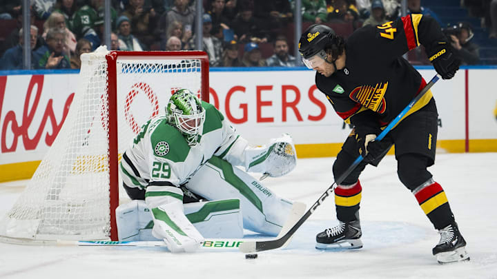 Nov 20, 2025; Vancouver, British Columbia, CAN; Dallas Stars goalie Jake Oettinger (29) makes a save on Vancouver Canucks forward Kiefer Sherwood (44) in the second period at Rogers Arena. Mandatory Credit: Bob Frid-Imagn Images