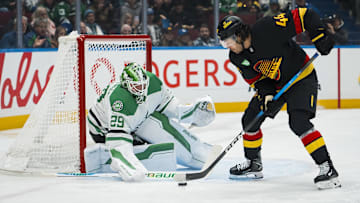 Nov 20, 2025; Vancouver, British Columbia, CAN; Dallas Stars goalie Jake Oettinger (29) makes a save on Vancouver Canucks forward Kiefer Sherwood (44) in the second period at Rogers Arena. Mandatory Credit: Bob Frid-Imagn Images