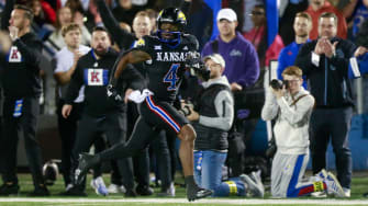 Kansas junior running back Devin Neal (4) runs in for a touchdown in the first quarter of Saturday's Sunflower Showdown against Kansas State inside David Booth Kansas Memorial Stadium.