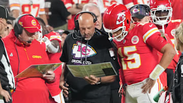Oct 7, 2024; Kansas City, Missouri, USA; Kansas City Chiefs quarterback Patrick Mahomes (15) looks at plays with offensive coordinator Matt Nagy, center, and head coach Andy Reid against the New Orleans Saints during the first half at GEHA Field at Arrowhead Stadium. Mandatory Credit: Denny Medley-Imagn Images