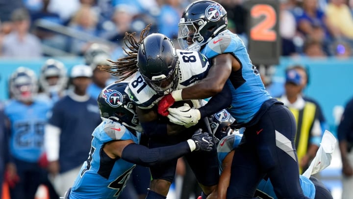 Seattle Seahawks wide receiver Laviska Shenault Jr. (81) is brought down by Tennessee Titans safety Mike Brown (44) and Tennessee Titans linebacker Otis Reese IV (41) during the second quarter at Nissan Stadium in Nashville, Tenn., Saturday, Aug. 17, 2024.