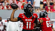 Sep 27, 2025; Raleigh, North Carolina, USA; North Carolina State Wolfpack quarterback CJ Bailey (11) with the ball during the first half of the game against Virginia Tech Hokies at Carter-Finley Stadium. Mandatory Credit: Jaylynn Nash-Imagn Images