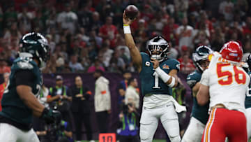 Philadelphia Eagles quarterback Jalen Hurts passes to Saquon Barkley against the Kansas City Chiefs during Super Bowl LIX