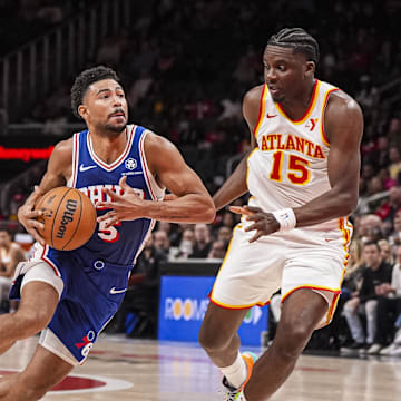 Mar 10, 2025; Atlanta, Georgia, USA; Philadelphia 76ers guard Quentin Grimes (5) drives to the basket against Atlanta Hawks center Clint Capela (15) during the first half at State Farm Arena. Mandatory Credit: Dale Zanine-Imagn Images