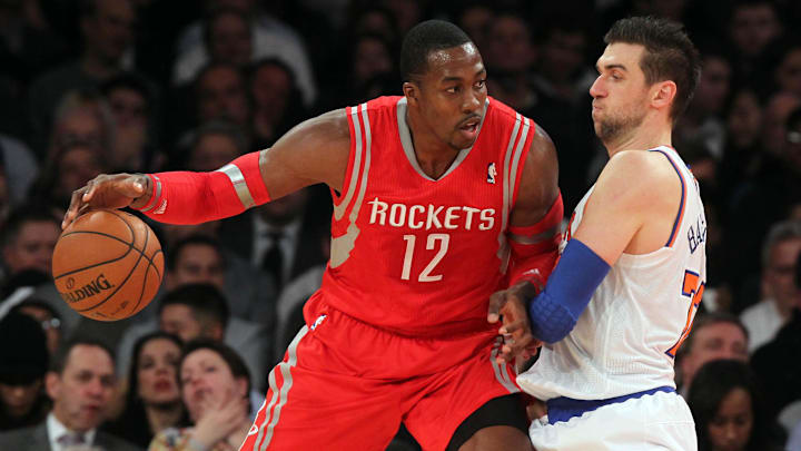 Nov 14, 2013; New York, NY, USA; Houston Rockets power forward Dwight Howard (12) controls the ball against New York Knicks power forward Andrea Bargnani (77) during the third quarter of a game at Madison Square Garden. The Rockets beat the Knicks 109-106. Mandatory Credit: Brad Penner-Imagn Images Nov 14, 2013; New York, NY, USA; Houston Rockets power forward Dwight Howard (12) controls the ball against New York Knicks power forward Andrea Bargnani (77) during the third quarter of a game at Madison Square Garden. The Rockets beat the Knicks 109-106. Mandatory Credit: Brad Penner-Imagn Images