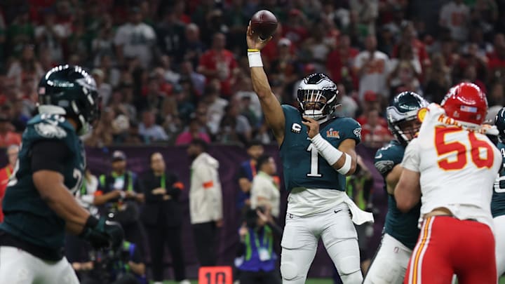 Philadelphia Eagles quarterback Jalen Hurts passes to Saquon Barkley against the Kansas City Chiefs during Super Bowl LIX