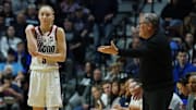 UConn Huskies head coach Geno Auriemma talks to guard Paige Bueckers from the sideline as they take on the St. John's Red Storm at Mohegan Sun Arena. 