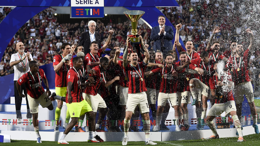 Alessio Romagnoli (C) of AC Milan lifts the Scudetto trophy...