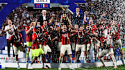 Alessio Romagnoli (C) of AC Milan lifts the Scudetto trophy...