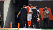 Cincinnati Bengals quarterback Joe Burrow is assisted to the locker room with an injury in the second quarter of the NFL Week 2 game between the Cincinnati Bengals and the Jacksonville Jaguars at Paycor Stadium in downtown Cincinnati on Sunday, Sept. 14, 2025. The Jaguars led 17-10 at halftime.
