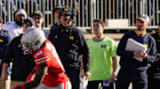 Michigan Wolverines head coach Jim Harbaugh watches from the sideline beside off-field analyst Connor Stalions, right, during the NCAA football game against the Ohio State Buckeyes at Ohio Stadium.