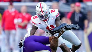 Ohio State Buckeyes linebacker Arvell Reese (8) tackles Washington Huskies quarterback Demond Williams Jr. (2) during the second half of the NCAA football game at Husky Stadium in Seattle on Sept. 27, 2025. Ohio State won 24-6.