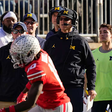 Nov 26, 2022; Columbus, Ohio, USA; Michigan Wolverines head coach Jim Harbaugh watches from the sideline beside off-field analyst Connor Stalions, right, during the NCAA football game against the Ohio State Buckeyes at Ohio Stadium.