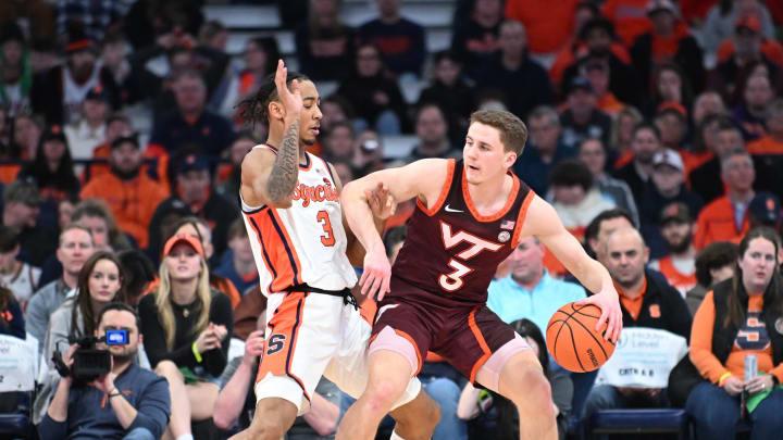 Feb 27, 2024; Syracuse, New York, USA; Virginia Tech Hokies guard Sean Pedulla (right) posts up against Syracuse Orange guard Judah Mintz in the second half at the JMA Wireless Dome. Mandatory Credit: Mark Konezny-USA TODAY Sports