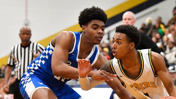 St. Xavier's Chance Dillingham (11) drives past Bryant's Camarion Bead (23) during their championship game in the King of The Bluegrass Tournament, Sunday, Dec. 22 2024 in Louisville Ky. St. Xavier's Chance Dillingham (11) drives past Bryant's Camarion Bead (23) during their championship game in the King of The Bluegrass Tournament, Sunday, Dec. 22 2024 in Louisville Ky.
