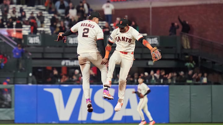 Apr 2, 2026; San Francisco, California, USA; San Francisco Giants infielders Willy Adames (2) and Luis Arraez (1) leap to celebrate after defeating the New York Mets in the ninth inning at Oracle Park. Mandatory Credit: Robert Edwards-Imagn Images