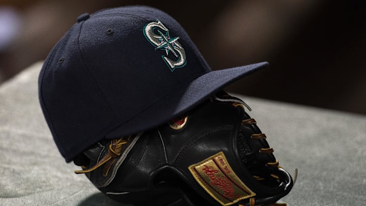 A Seattle Mariners hat and glove is pictured before a game against the Texas Ranger on April 27, 2015, at Globe Life Field. A Seattle Mariners hat and glove is pictured before a game against the Texas Ranger on April 27, 2015, at Globe Life Field.