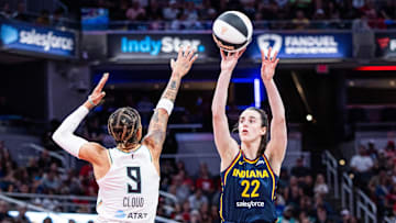Jun 14, 2025; Indianapolis, Indiana, USA; Indiana Fever guard Caitlin Clark (22) shoots the ball while New York Liberty guard Natasha Cloud (9) defends in the first half at Gainbridge Fieldhouse. Mandatory Credit: Trevor Ruszkowski-Imagn Images