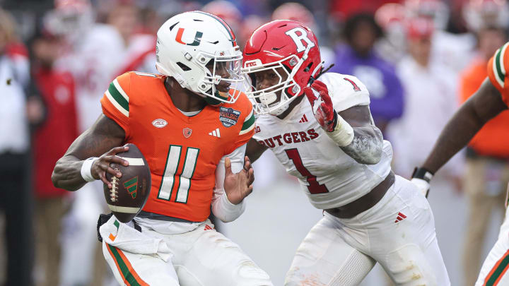 Miami quarterback Jacurri Brown (11) is sacked by Rutgers linebacker Mohamed Toure 