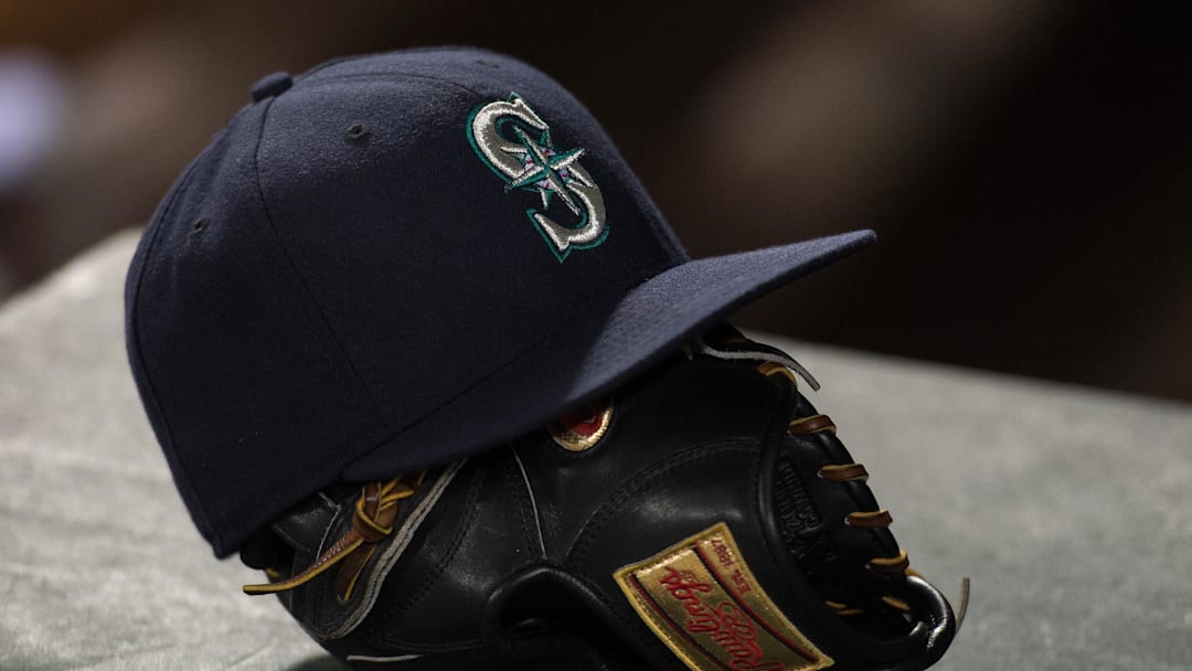 Apr 27, 2015; Arlington, TX, USA; A view of a Seattle Mariners hat and baseball glove during the game between the Texas Rangers and the Mariners at Globe Life Park in Arlington. The Mariners defeated the Rangers 3-1. Mandatory Credit: Jerome Miron-Imagn Images