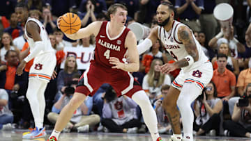 Mar 8, 2025; Auburn, Alabama, USA; Alabama Crimson Tide forward Grant Nelson (4) moves to the basket as Auburn Tigers forward Johni Broome (4) defends during the second half at Neville Arena. Mandatory Credit: John Reed-Imagn Images