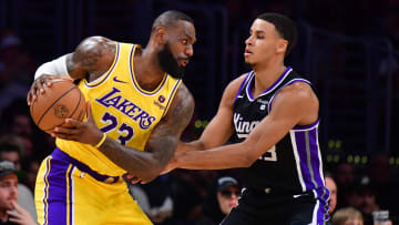 Mar 6, 2024; Los Angeles, California, USA;  Los Angeles Lakers forward LeBron James (23) moves the ball against Sacramento Kings forward Keegan Murray (13) during the first half at Crypto.com Arena. Mandatory Credit: Gary A. Vasquez-USA TODAY Sports